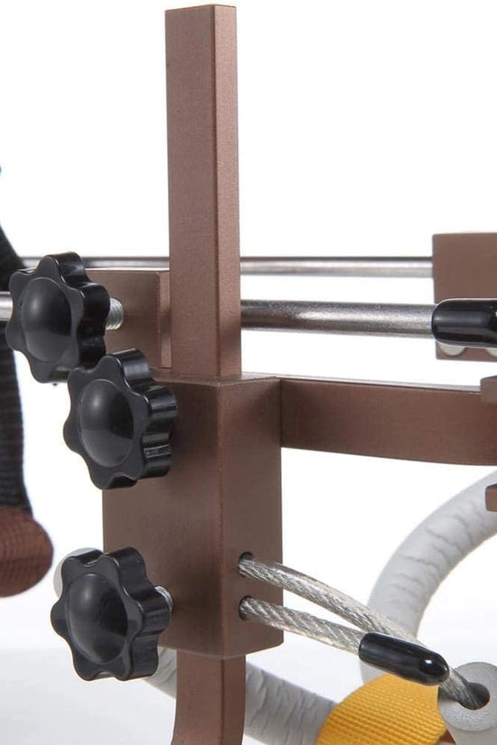 Freedom Walker wheelchair adjustment knobs close-up – Orange Vest & Brown Frame, showing black knobs and steel rods.