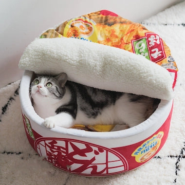 Cat lying inside a Ramen Noodle Cat Nest