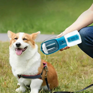 Person using a pet grooming tool on a dog in a grassy area