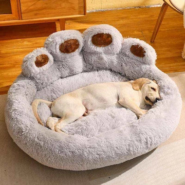 Dog lying on a  Sofa Nest Pet Bed in a home setting.
