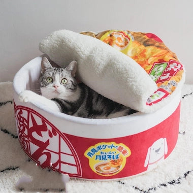 Cat lying inside a Ramen Noodle Cat Nest
